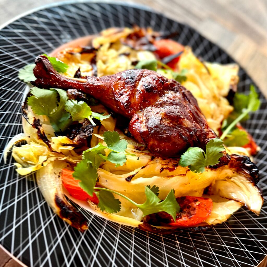 Char Siu Duck Leg over Braised Cabbage